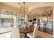 Stylish dining room with a view of the living spaces and outdoor patio at 1617 E Copper Holw, Queen Creek, AZ 85140