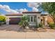Charming single-story home with a well-maintained yard, mature landscaping, and a two-car garage at 1617 E Copper Holw, Queen Creek, AZ 85140