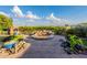 Stunning backyard featuring a custom stone fire pit, lush greenery, and meticulous landscaping, perfect for outdoor enjoyment at 1617 E Copper Holw, Queen Creek, AZ 85140