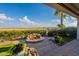 Beautiful backyard with a captivating fire pit, lush plants, and manicured landscaping creating a serene outdoor retreat at 1617 E Copper Holw, Queen Creek, AZ 85140