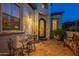 Inviting front entry with decorative door, seating area and brick-paved patio at 1617 E Copper Holw, Queen Creek, AZ 85140