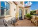 Inviting front porch with a wrought-iron entry door, cozy seating, and charming curb appeal at 1617 E Copper Holw, Queen Creek, AZ 85140