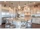 Spacious kitchen island with seating, pendant lighting, and granite countertops at 1617 E Copper Holw, Queen Creek, AZ 85140
