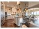 Gourmet kitchen boasts custom cabinets, stainless steel appliances, and a center island with seating at 1617 E Copper Holw, Queen Creek, AZ 85140