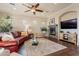 Inviting living room with a stone fireplace, dark hardwood floors, and a comfortable leather sofa at 1617 E Copper Holw, Queen Creek, AZ 85140