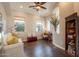 Comfortable living room featuring wood floors, decorative shelving, and a relaxing space at 1617 E Copper Holw, Queen Creek, AZ 85140