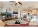 Open-concept living room with stone fireplace, and access to gourmet kitchen at 1617 E Copper Holw, Queen Creek, AZ 85140