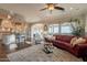 Bright living room with a comfortable leather sofa and large windows showcasing the view at 1617 E Copper Holw, Queen Creek, AZ 85140