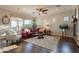 Spacious living room with a fireplace, large windows, comfortable seating, and stylish decor at 1617 E Copper Holw, Queen Creek, AZ 85140