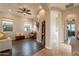 Inviting living room with wood floors, arched doorways, and a cozy seating area at 1617 E Copper Holw, Queen Creek, AZ 85140