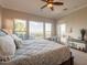 Bright main bedroom featuring windows, outdoor views, and a cozy chair at 1617 E Copper Holw, Queen Creek, AZ 85140