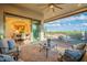 Inviting covered patio with stylish furniture, offering a serene outdoor living space and beautiful backyard views at 1617 E Copper Holw, Queen Creek, AZ 85140