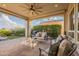 Charming backyard patio with cozy seating, outdoor kitchen area, and lush landscaping for relaxation and outdoor gatherings at 1617 E Copper Holw, Queen Creek, AZ 85140