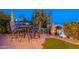 Outdoor patio featuring a dining table set, garden decor, and lush greenery for relaxation and stylish entertaining at 1617 E Copper Holw, Queen Creek, AZ 85140