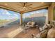 Cozy covered patio featuring comfortable seating, a ceiling fan, and views of the lush landscaping at 1617 E Copper Holw, Queen Creek, AZ 85140