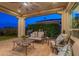 Large covered patio with comfortable seating and a ceiling fan at 1617 E Copper Holw, Queen Creek, AZ 85140