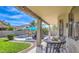 Covered patio with view of refreshing pool, lush grass, and mature landscaping in backyard at 1697 E Linda Ln, Gilbert, AZ 85234