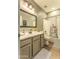 The bathroom features a vanity, mirror, toilet, shower-tub combo with a floral curtain at 1697 E Linda Ln, Gilbert, AZ 85234