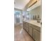 Neutral bathroom with a single sink vanity, shower-tub combo, and a large mirror at 1697 E Linda Ln, Gilbert, AZ 85234