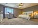 Spacious bedroom featuring a comfortable bed, treadmill, ceiling fan, and natural light at 1697 E Linda Ln, Gilbert, AZ 85234