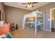 This bedroom features a bed, built-in desk, ceiling fan, and neutral carpeting at 1697 E Linda Ln, Gilbert, AZ 85234