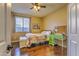 Comfortable bedroom with hardwood floors, a large window, and a decorative desk at 1697 E Linda Ln, Gilbert, AZ 85234