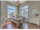 Sunlit dining room with modern farmhouse table and backyard views at 1697 E Linda Ln, Gilbert, AZ 85234