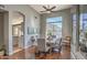 Dining room with wood floors, ceiling fan, and backyard views at 1697 E Linda Ln, Gilbert, AZ 85234
