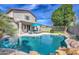 Backyard pool with waterfall feature and desert landscaping at 1697 E Linda Ln, Gilbert, AZ 85234