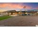 Spacious backyard featuring a covered patio, low-maintenance landscaping, and gravel ground covering at 1801 E Berridge Ln, Phoenix, AZ 85016