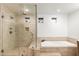 Bathroom with a glass shower and a tub, plus beige tile and a shower niche at 1801 E Berridge Ln, Phoenix, AZ 85016