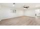 Spacious bedroom with wood-look flooring, a ceiling fan and natural light at 1801 E Berridge Ln, Phoenix, AZ 85016