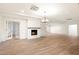 Bright living room with light wood-look tile floors, fireplace, and open floor plan at 1801 E Berridge Ln, Phoenix, AZ 85016