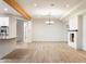 Bright and airy living room with wood flooring, a modern fireplace, and an elegant chandelier at 1801 E Berridge Ln, Phoenix, AZ 85016
