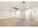 Spacious living room featuring light wood-look tile floors, neutral walls, and ceiling fan at 1801 E Berridge Ln, Phoenix, AZ 85016