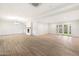 Bright living room with white walls, light wood-look tile floors, and a modern fireplace at 1801 E Berridge Ln, Phoenix, AZ 85016