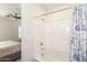Bathroom features a tub with shower and an adjacent bedroom visible from the doorway at 19847 W Monroe St, Buckeye, AZ 85326