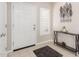 Inviting foyer with neutral tones, a console table, and a decorative leaf sculpture at 19847 W Monroe St, Buckeye, AZ 85326