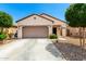 Charming single-story home with a well-maintained front yard and attached two-car garage at 19847 W Monroe St, Buckeye, AZ 85326