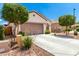 Single-story home with a 2-car garage, desert landscaping, and a paved driveway at 19847 W Monroe St, Buckeye, AZ 85326