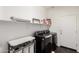 Laundry room with washer and dryer, as well as storage shelving at 19847 W Monroe St, Buckeye, AZ 85326