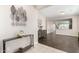 Open-concept living room with wood floors, stylish furniture, and view to the kitchen at 19847 W Monroe St, Buckeye, AZ 85326