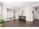 Bright living room with dark wood floors, a console table, and view of the entryway at 19847 W Monroe St, Buckeye, AZ 85326