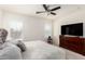 Bright, spacious main bedroom with ceiling fan, and shuttered windows, allowing for ample natural light at 19847 W Monroe St, Buckeye, AZ 85326