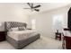 Comfortable main bedroom with neutral walls, carpet flooring, a ceiling fan, and shuttered windows at 19847 W Monroe St, Buckeye, AZ 85326