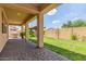 Covered back patio with brick pavers overlooking a grassy backyard at 2046 E Paradise Ln, Phoenix, AZ 85022