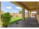 Covered back patio with brick pavers overlooking a grassy backyard at 2046 E Paradise Ln, Phoenix, AZ 85022
