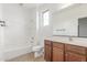 A clean and well-lit bathroom with a tiled shower, tub, vanity, and toilet at 2046 E Paradise Ln, Phoenix, AZ 85022