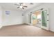 Bright bedroom with ceiling fan, balcony access, and stained glass windows at 2046 E Paradise Ln, Phoenix, AZ 85022