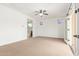 Bright bedroom with ceiling fan, balcony access, and stained glass windows at 2046 E Paradise Ln, Phoenix, AZ 85022